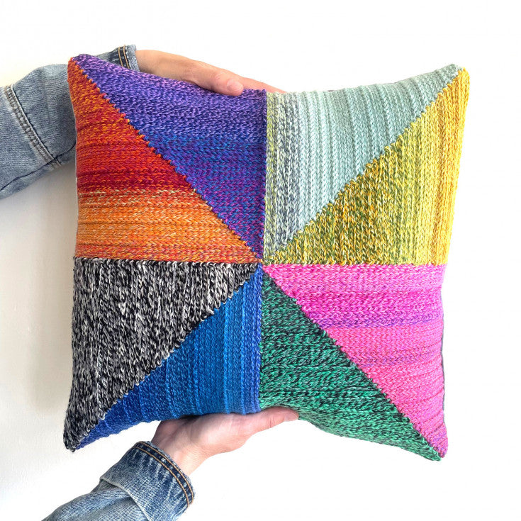 Colorful pinwheel design on crocheted pillow created on 5-Mesh canvas.
