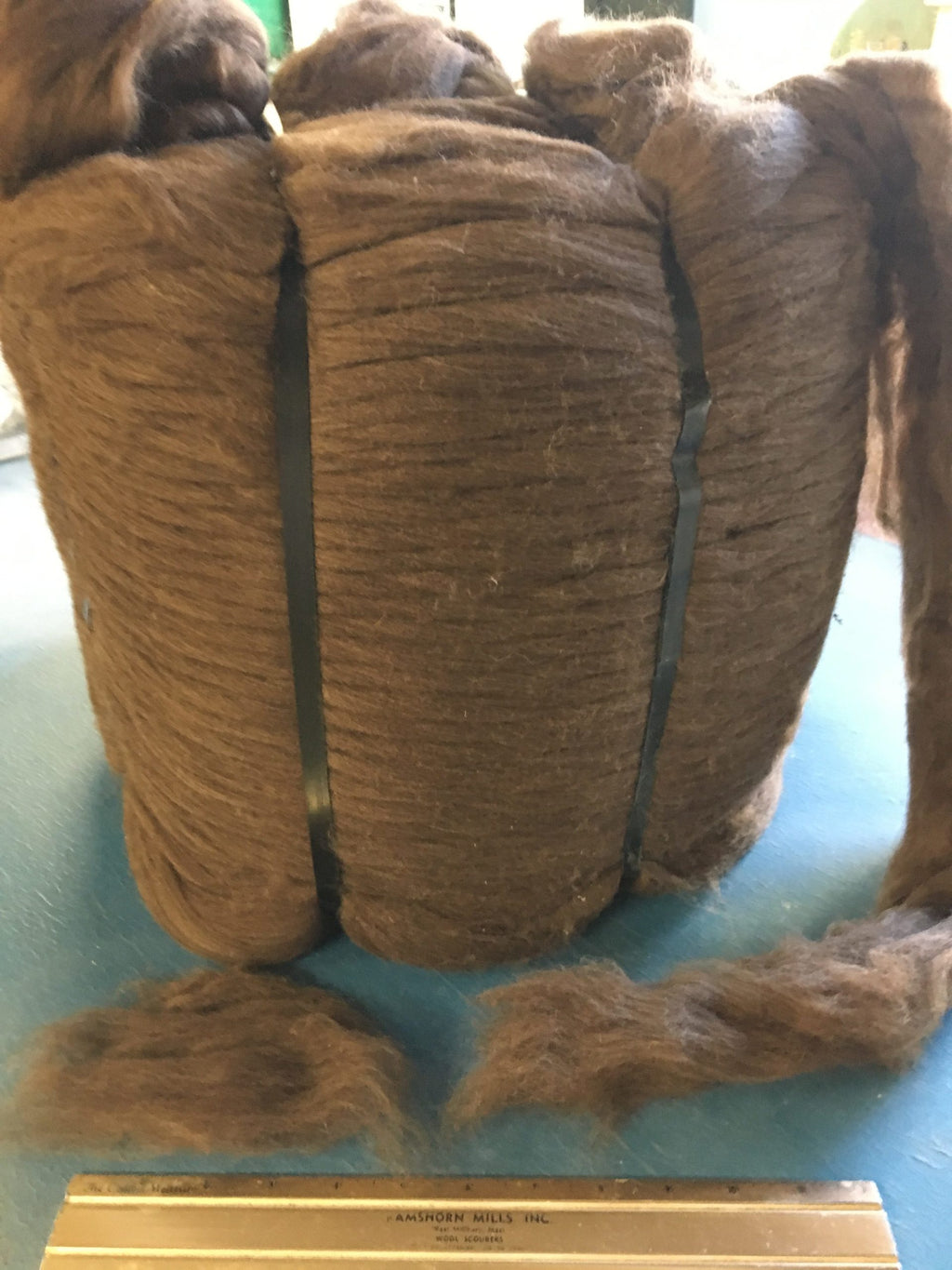 Natural brown Merino wool top roving shown as a full bump
