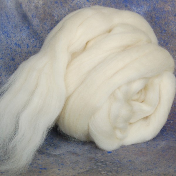 Close view of a full bump of off-white wool top roving