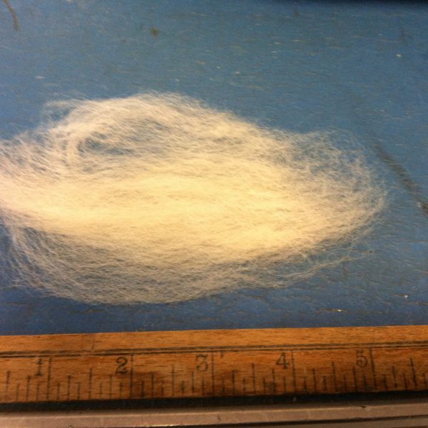 Close view of off-white wool top roving fiber