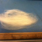 Close view of off-white wool top roving fiber