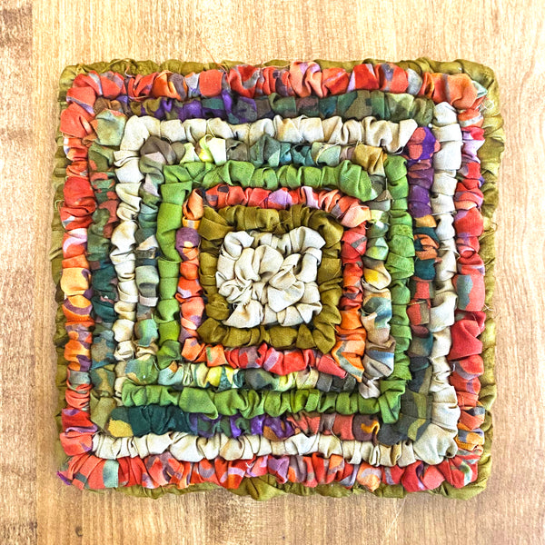 Locker Hooked Coaster in autumn colored hand dyed cotton fabric strips on 3.75 Mesh Canvas.