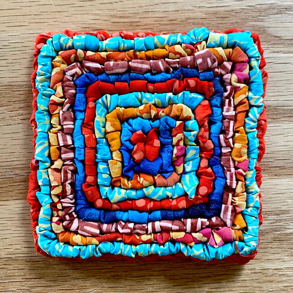 Locker Hooked Coaster in multi colored hand dyed cotton fabric strips on 3.75 Mesh Canvas.
