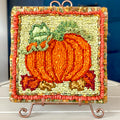 Princess pumpkin locker hooked pattern on 5-mesh canvas with ribbon and fabric strips.